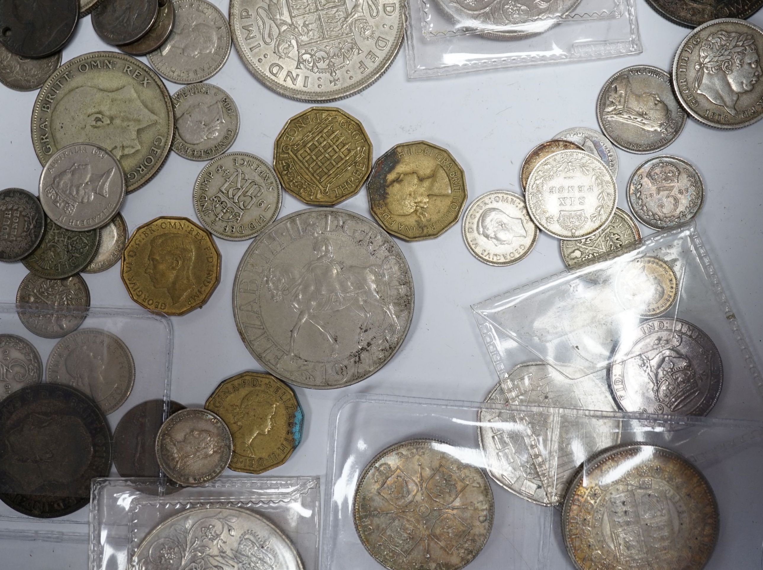 A group of UK coins including 1819, 1821 and 1891 crowns, two 1887 half crowns, 1887 florin, etc.